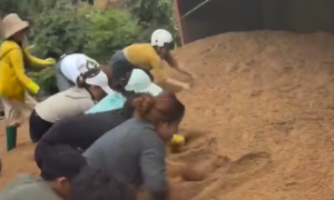 Sand truck overturns, burying passerby to death