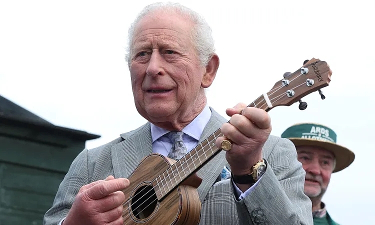 King Charles plays ukulele with locals