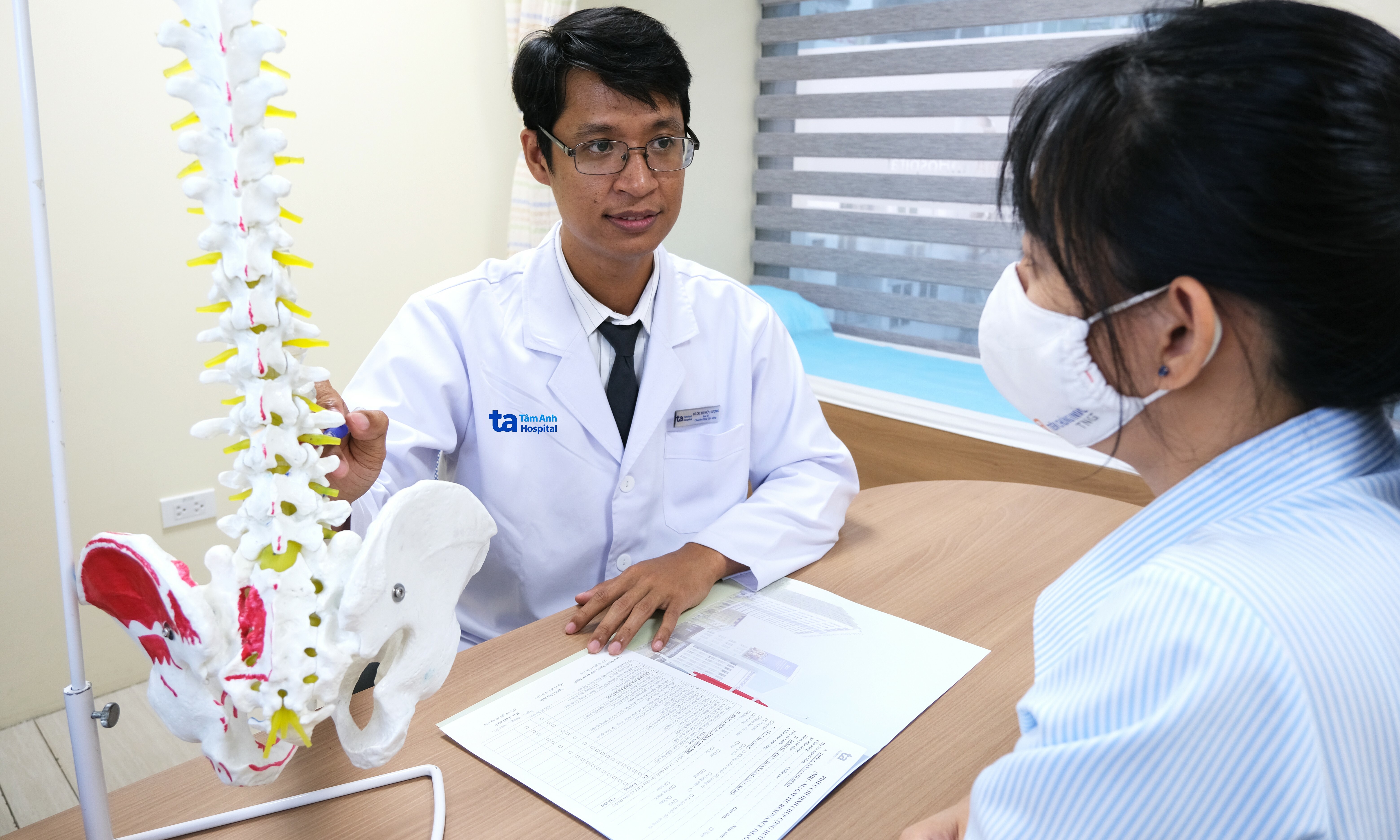 What conditions does back pain with leg numbness warn of?