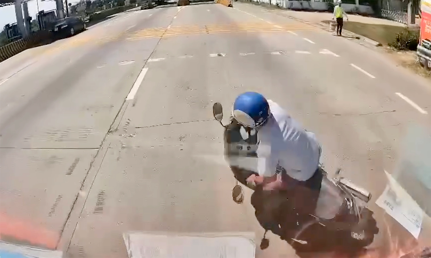 Motorcycle swerves, falls in front of car