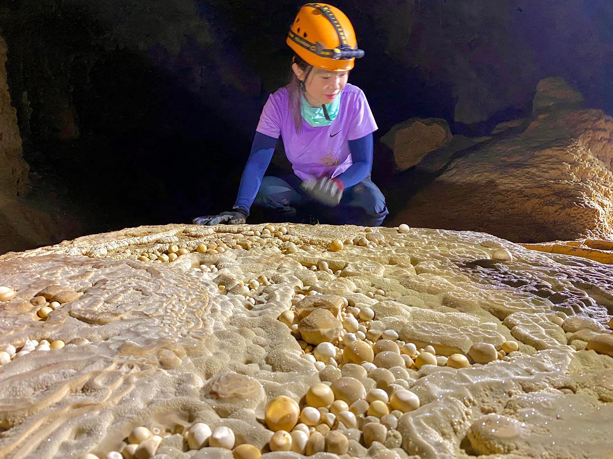 How is Hung cave, home to cave pearls, exploited for tourism?