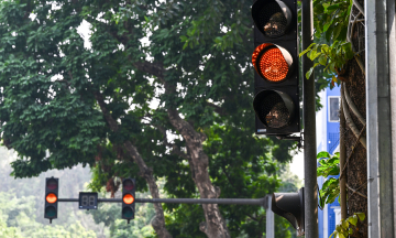 Are drivers penalized for being unable to stop at a yellow light?