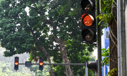 Are drivers penalized for being unable to stop at a yellow light?
