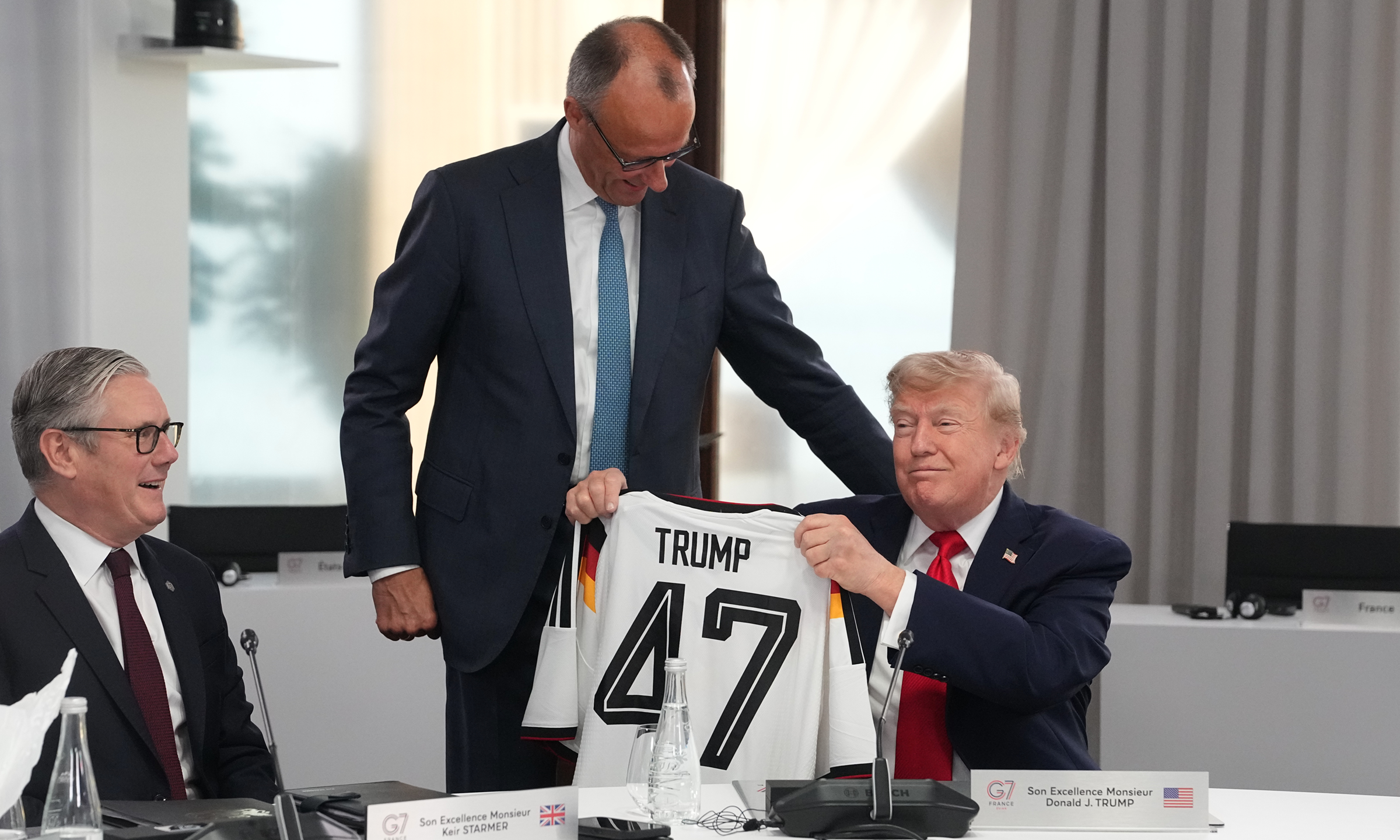 Trump receives jersey from German chancellor, bicycle from French president at G7 summit