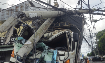 Truck rolls into three vehicles, breaks power pole
