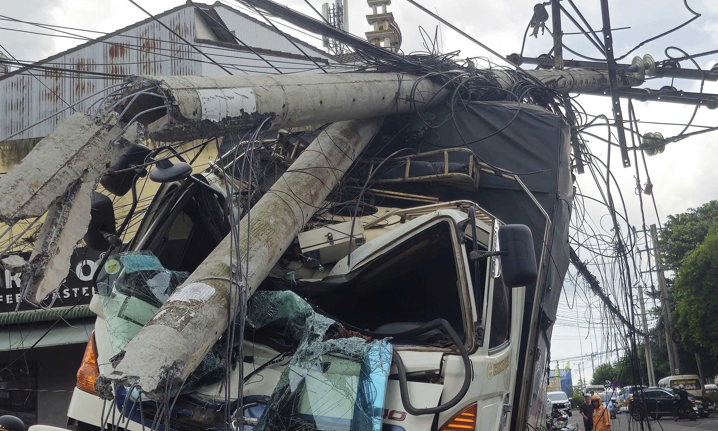 Truck rolls into three vehicles, breaks power pole