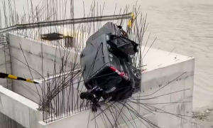 Car plunges from tunnel onto steel piles at construction site