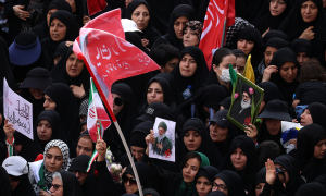 Iranians wave 'blood flags of revenge' at former leader's funeral