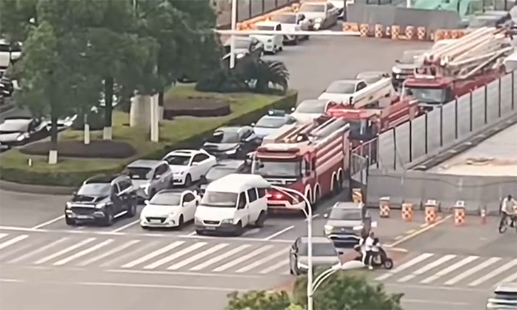 Car blocks fire truck while stopped at red light