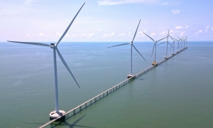 Sea bridge in Ca Mau offers visitors views of a wind farm