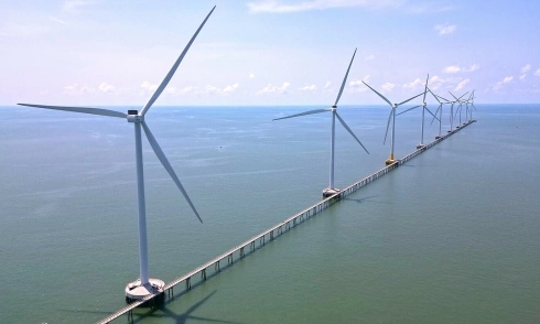 Sea bridge in Ca Mau offers visitors views of a wind farm