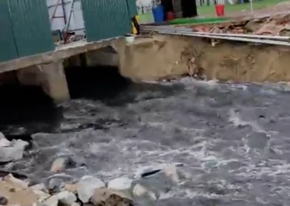Black wastewater flows onto Sam Son beach