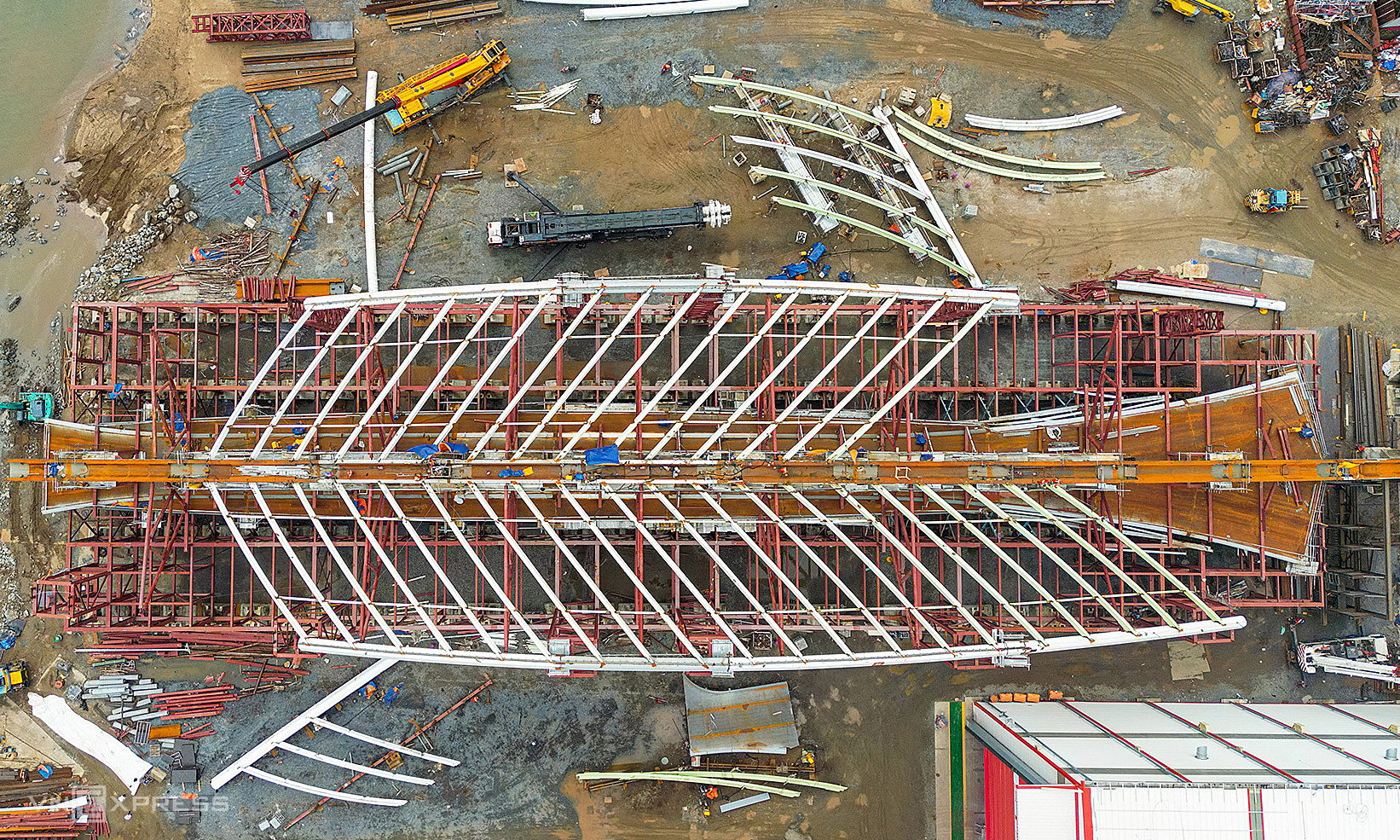 Construction site assembling 3,400-ton pedestrian bridge arch over Saigon river