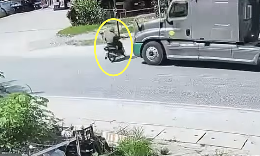 Careless road crossing leads to motorcycle collision with container truck