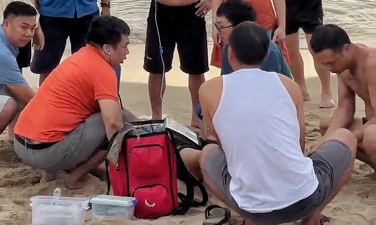 Medical team performs chest compressions to save drowning victim at sea