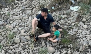 Commune official swims into swift current to rescue boy