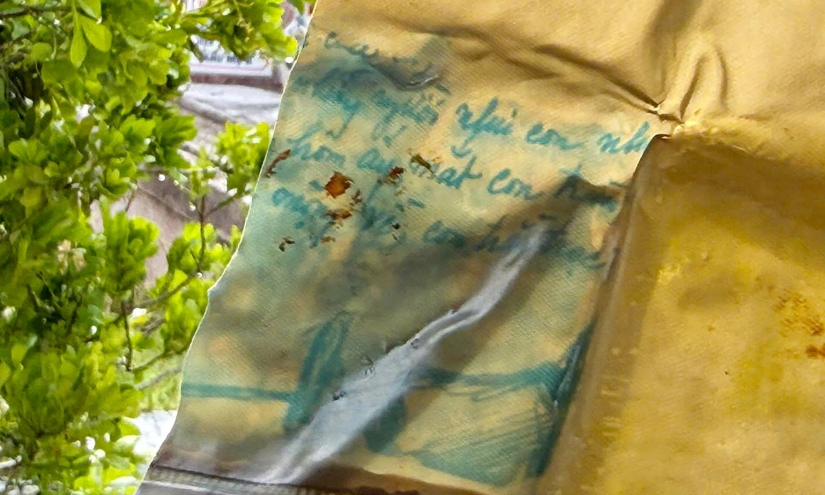 Piece of tarp with handwritten notes found in martyr's grave