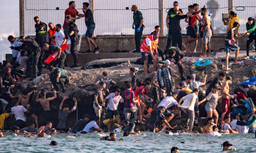 A chaotic day as tens of thousands of migrants flood into Spain