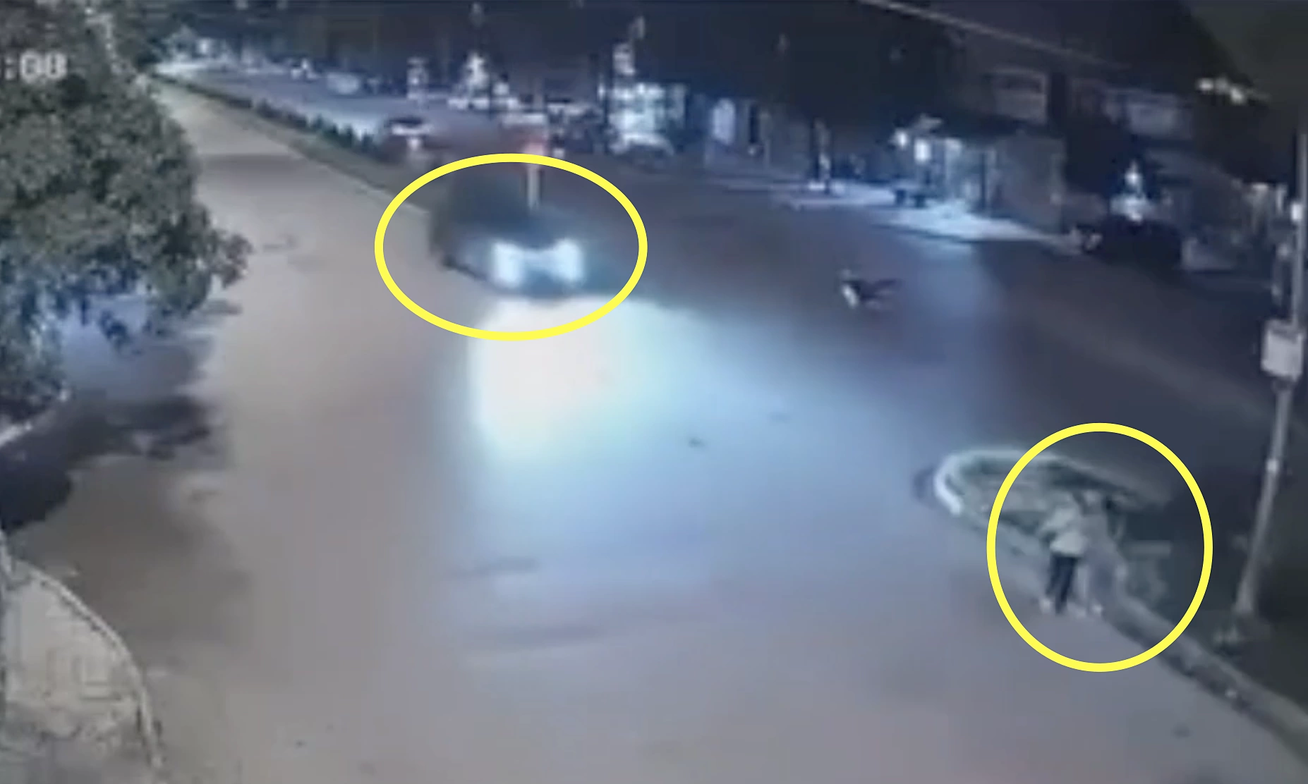 Car strikes two pedestrians walking in road