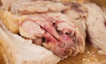 Should you eat or discard chicken with red bones after boiling?