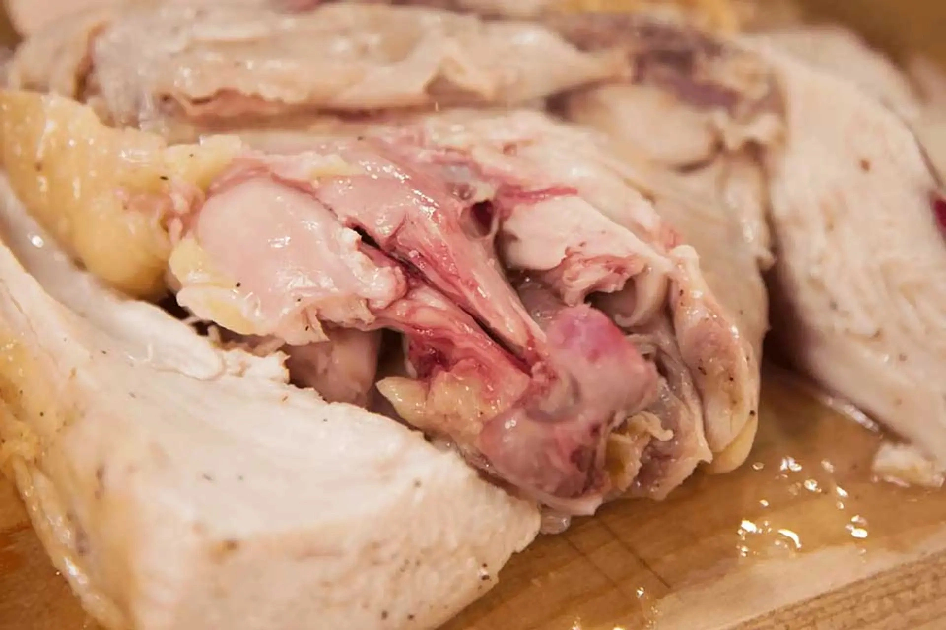 Should you eat or discard chicken with red bones after boiling?