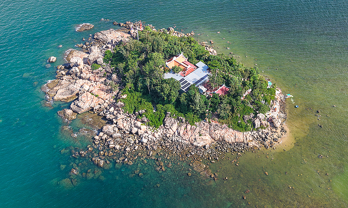 A pagoda situated on a 'rock garden' in the middle of Nha Trang Bay