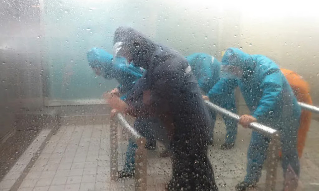 Chinese tourists pay to experience simulated storms and floods