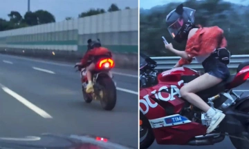 Female biker drives motorcycle over 200 km/h while filming with one hand