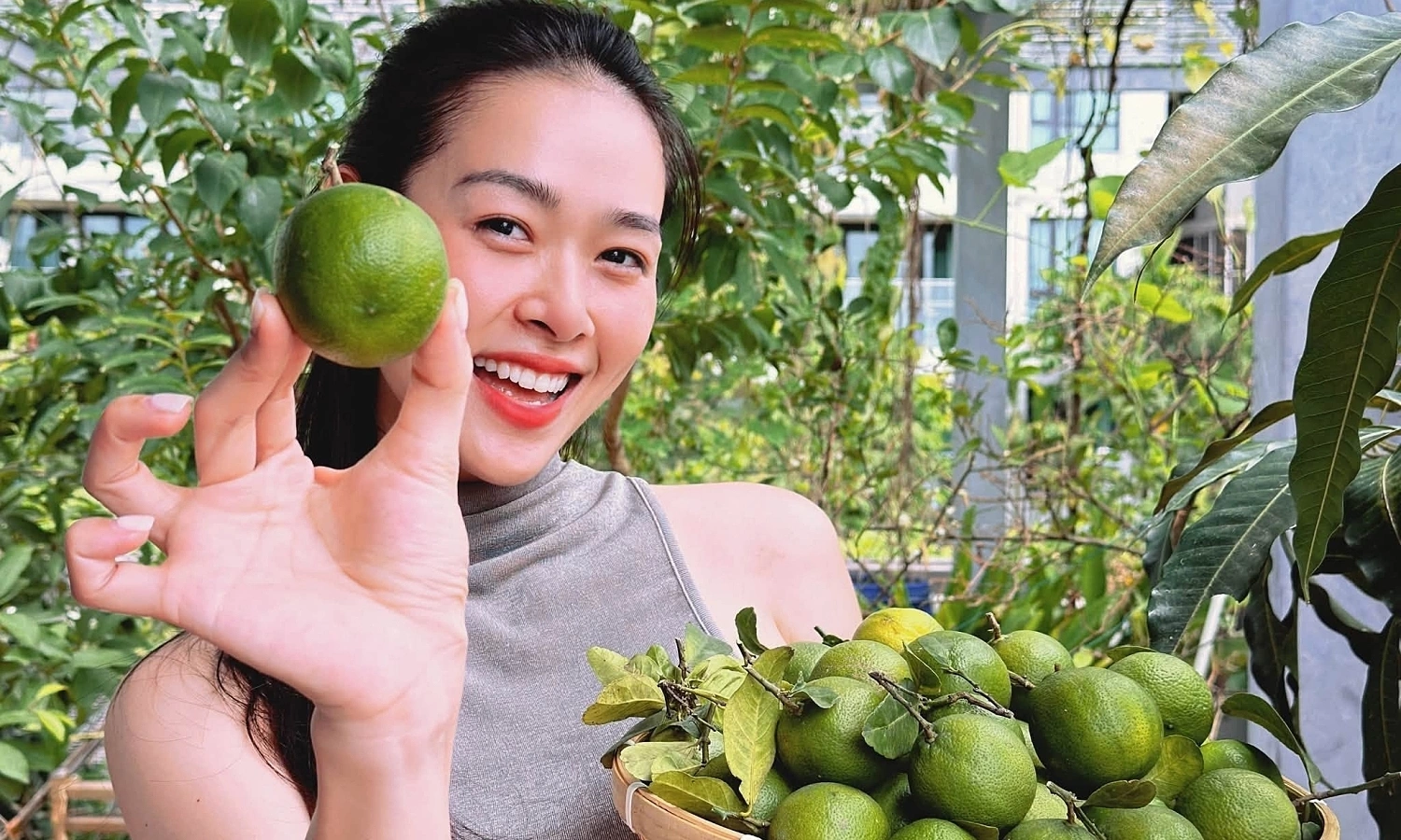 Diep Bao Ngoc harvests fruit from her rooftop garden