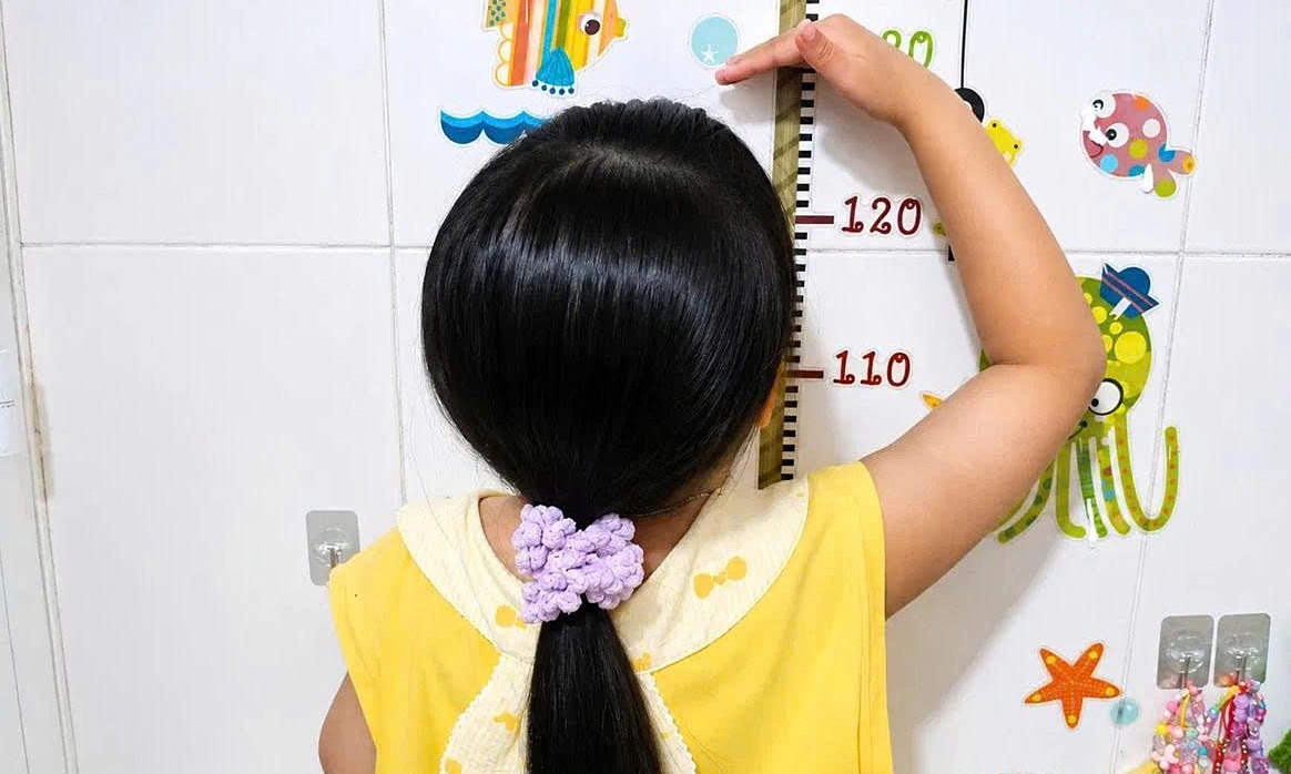 Why is monitoring children's height during puberty essential?