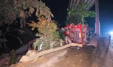 Tractor-trailer overturns into residential home, three dead