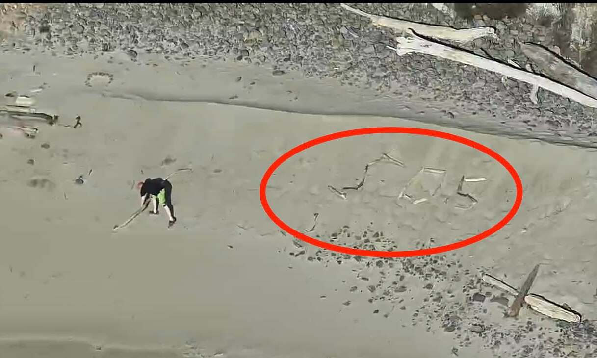 Tourists rescued after spelling 'SOS' with driftwood